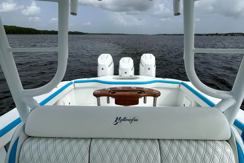 Blue Eyed Yacht Photos Pics 2016 Yellowfin 39 boat interior with triple engines on a calm water backdrop.