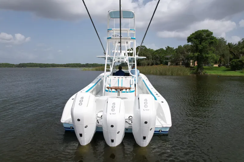 Blue Eyed Yacht Photos Pics 2016 Yellowfin 39 boat with four powerful outboard engines on a calm lake.
