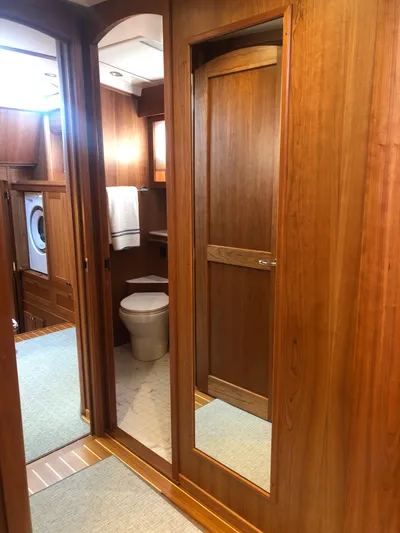 Apricity Yacht Photos Pics 2021 Sabre 58 Salon Express interior with wooden finish, featuring a bathroom and laundry area.