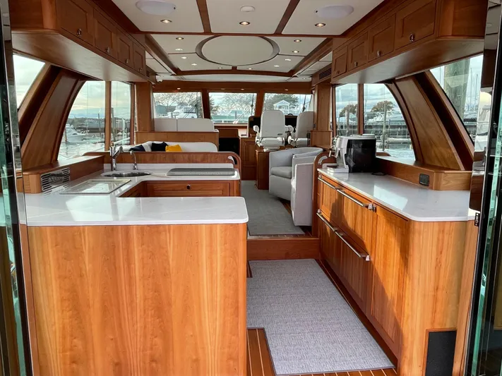 Apricity Yacht Photos Pics Luxurious interior of 2021 Sabre 58 Salon Express yacht with modern kitchen and seating area.