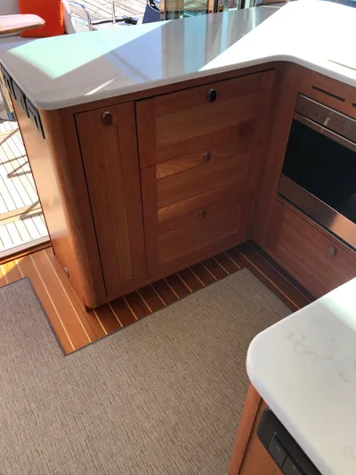 Apricity Yacht Photos Pics 2021 Sabre 58 Salon Express kitchen with wooden cabinetry and modern appliances.