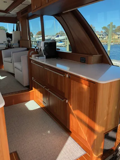 Apricity Yacht Photos Pics 2021 Sabre 58 Salon Express interior with elegant wood cabinetry and waterfront view.