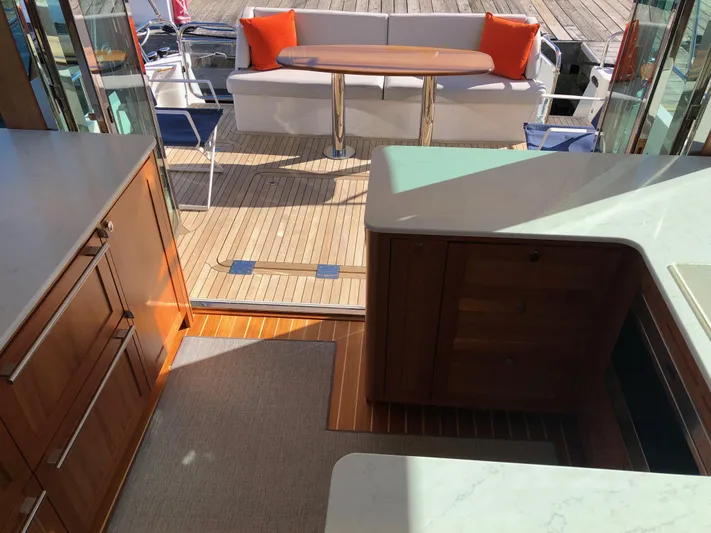 Apricity Yacht Photos Pics Interior view of 2021 Sabre 58 Salon Express yacht with elegant seating and wooden cabinetry.