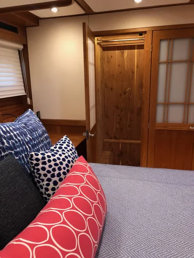 Apricity Yacht Photos Pics Interior of 2021 Sabre 58 Salon Express with cozy bedding and wooden door.