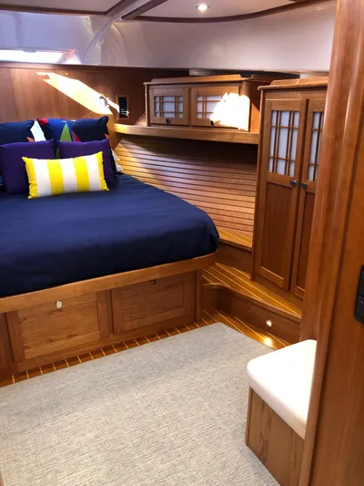 Apricity Yacht Photos Pics Luxurious 2021 Sabre 58 Salon Express cabin with elegant wood finish and cozy bedding.