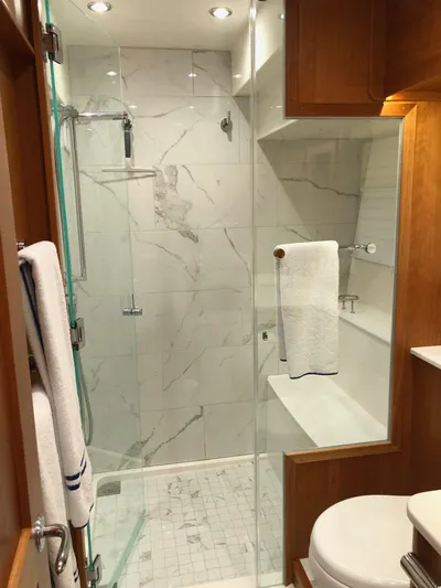 Apricity Yacht Photos Pics Luxurious bathroom in 2021 Sabre 58 Salon Express yacht with glass shower and elegant fixtures.