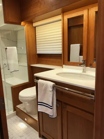 Apricity Yacht Photos Pics Luxurious bathroom in 2021 Sabre 58 Salon Express yacht with wood cabinetry and modern fixtures.
