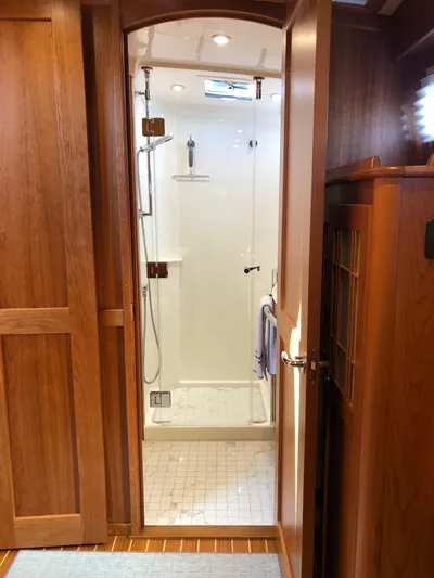Apricity Yacht Photos Pics 2021 Sabre 58 Salon Express yacht bathroom with wooden door and modern shower.