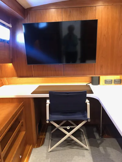 Apricity Yacht Photos Pics 2021 Sabre 58 Salon Express interior with desk, chair, and large TV.