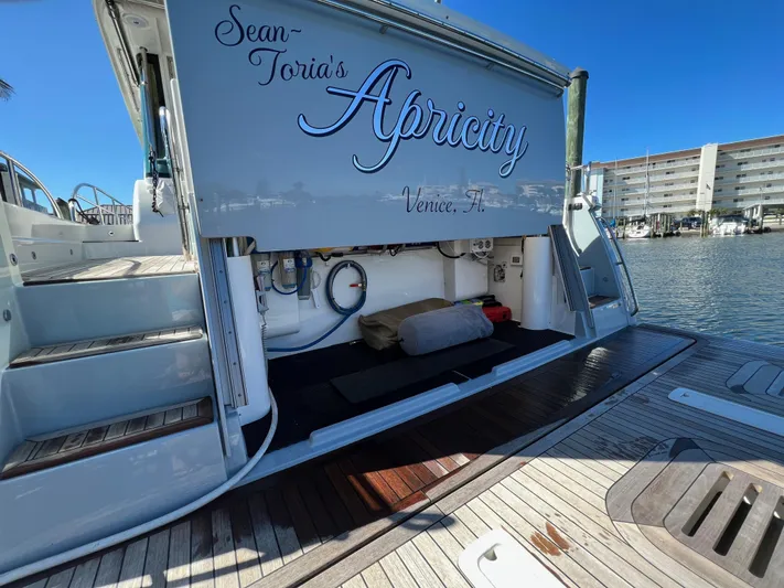Apricity Yacht Photos Pics 2021 Sabre 58 Salon Express yacht docked, open storage compartment, sunny marina view.