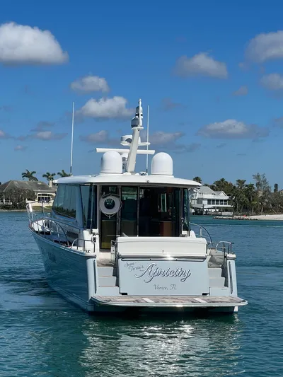 Apricity Yacht Photos Pics 2021 Sabre 58 Salon Express yacht on calm water, clear sky background.