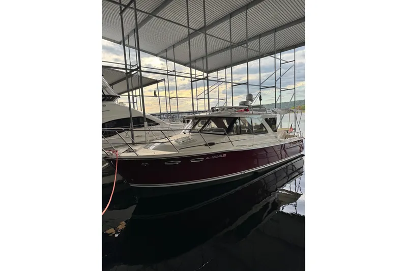 Fluidmotion Yacht Photos Pics 2020 Cutwater C-30S boat docked in a covered marina, reflecting on water.