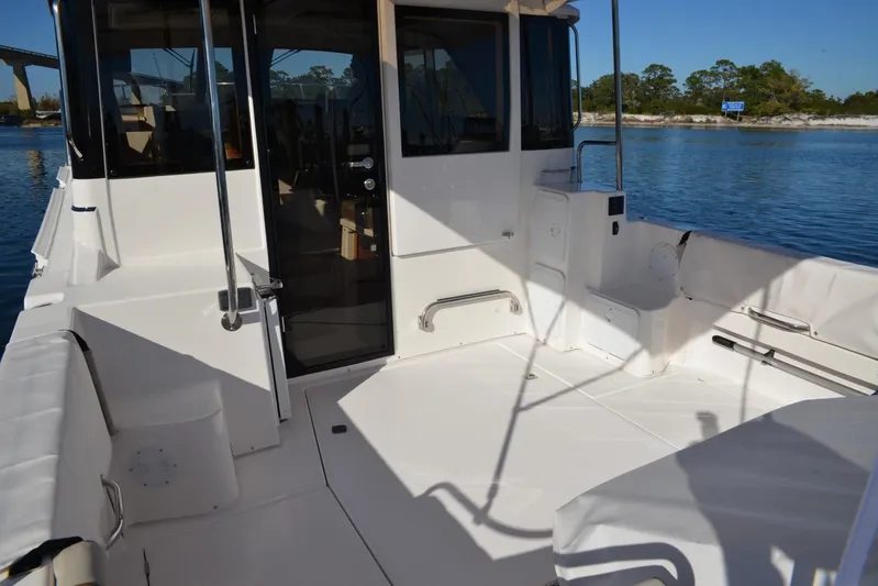 Fluidmotion Yacht Photos Pics 2020 Cutwater C-30S boat deck with seating, docked on calm water.