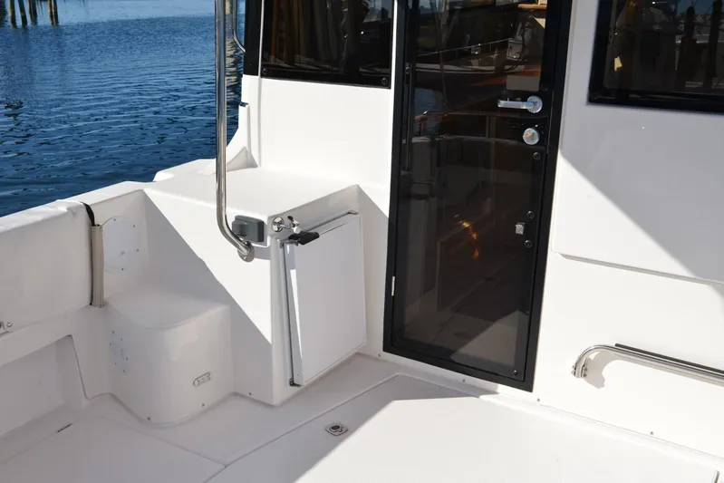 Fluidmotion Yacht Photos Pics 2020 Cutwater C-30S boat deck with glass door and railing by the water.