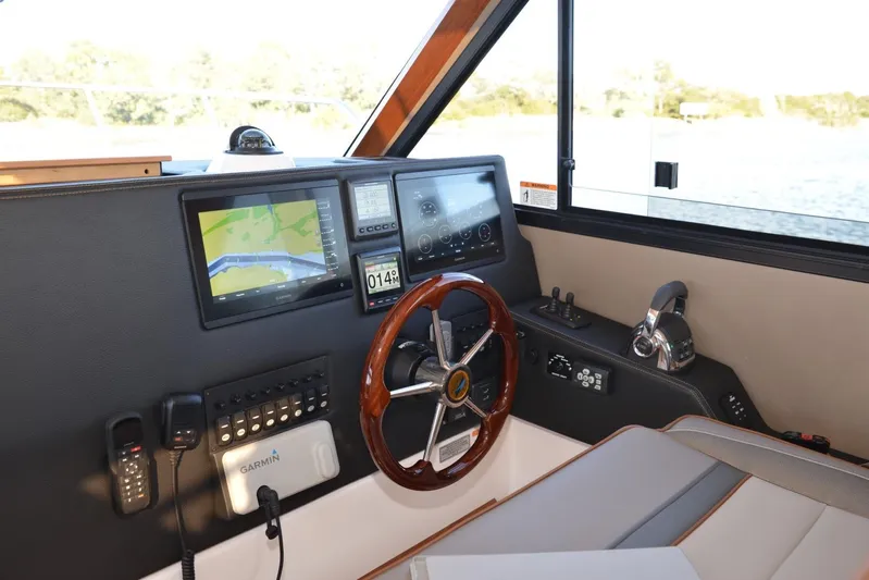 Fluidmotion Yacht Photos Pics 2020 Cutwater C-30S helm with navigation screens, steering wheel, and control panel.