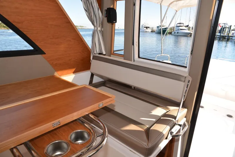 Fluidmotion Yacht Photos Pics 2020 Cutwater C-30S interior with seating, table, and waterfront view.