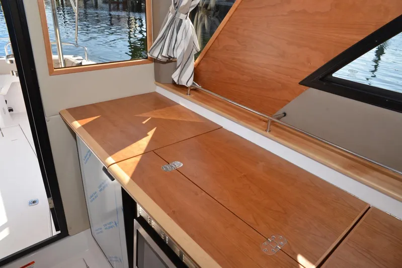 Fluidmotion Yacht Photos Pics Interior of 2020 Cutwater C-30S boat with wooden cabinetry and window view.