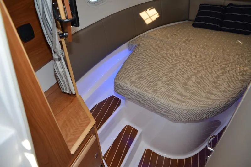 Fluidmotion Yacht Photos Pics 2020 Cutwater C-30S cabin interior with bed, wood accents, and ambient lighting.