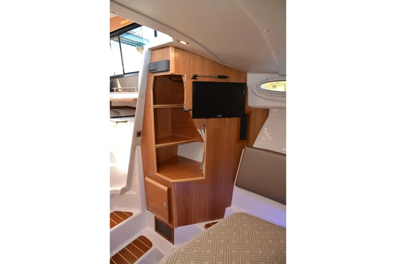 Fluidmotion Yacht Photos Pics 2020 Cutwater C-30S interior with wooden cabinetry and mounted TV.