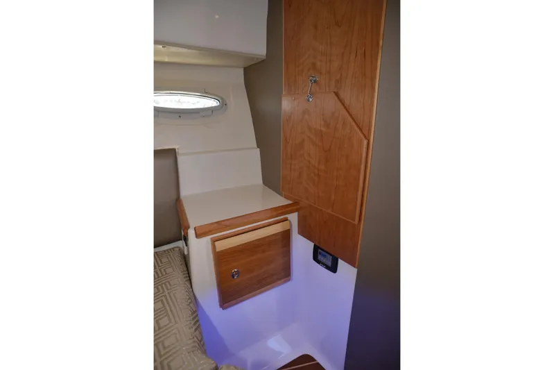 Fluidmotion Yacht Photos Pics 2020 Cutwater C-30S interior with wooden cabinetry and porthole window.