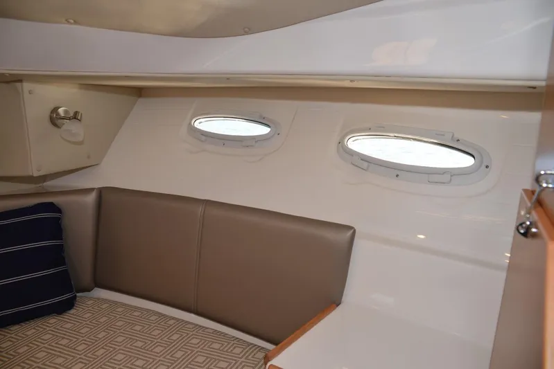 Fluidmotion Yacht Photos Pics 2020 Cutwater C-30S interior cabin with portholes, cushioned seating, and modern design.