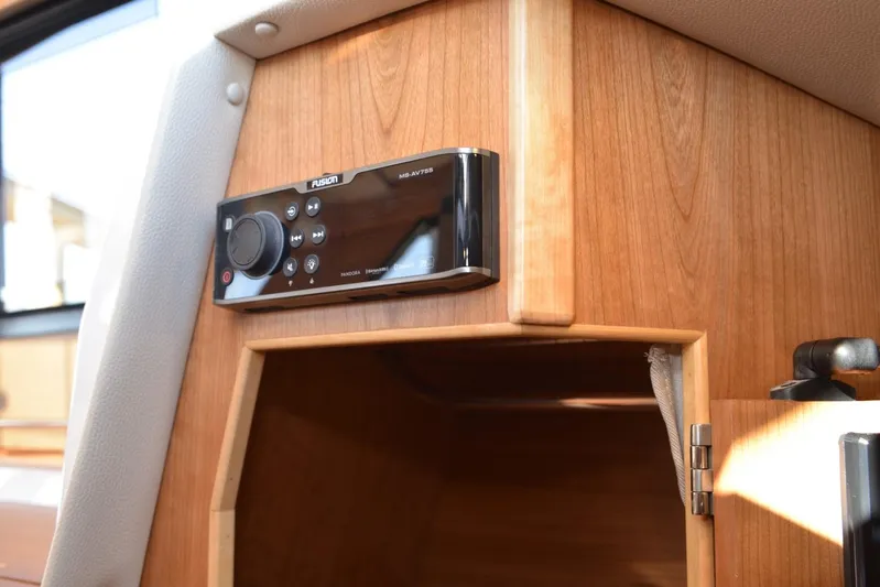 Fluidmotion Yacht Photos Pics Fusion audio system in 2020 Cutwater C-30S boat interior, mounted on wooden panel.