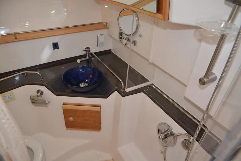 Fluidmotion Yacht Photos Pics 2020 Cutwater C-30S boat bathroom with modern fixtures and blue vessel sink.