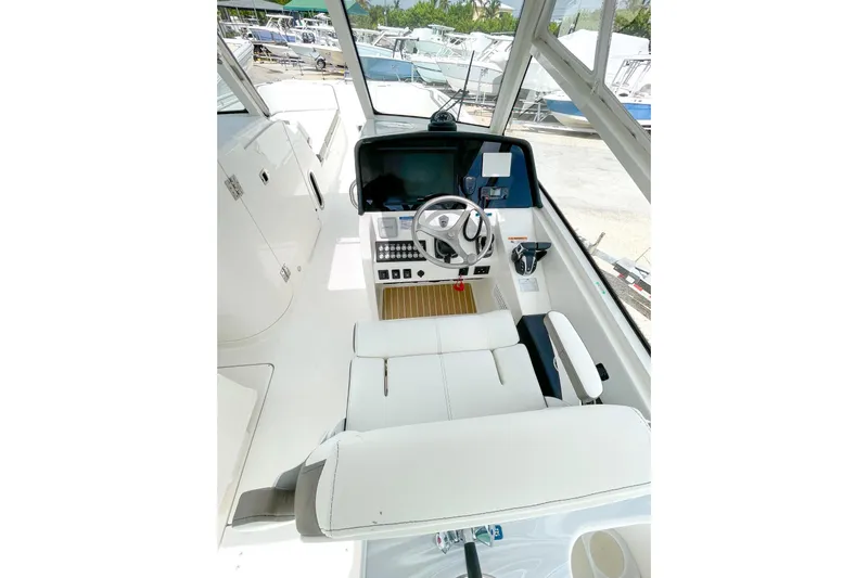  Yacht Photos Pics 2021 World Cat 325 DC boat interior with steering wheel and control panel.