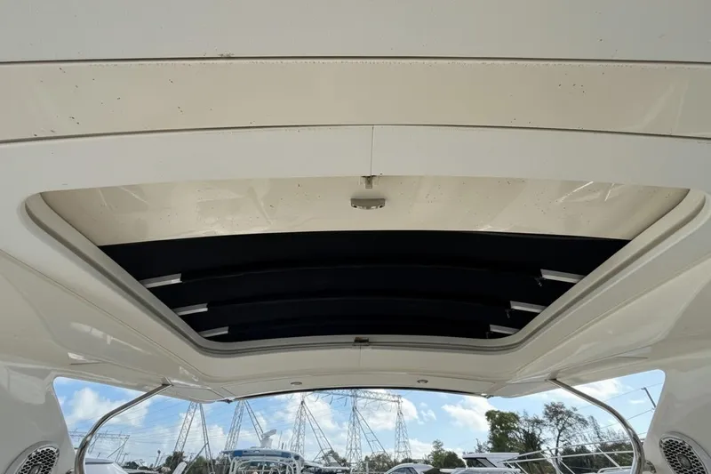 Yacht Photos Pics 2015 Sea Ray SLX 350 boat interior roof with open sunroof, showcasing sky and trees.