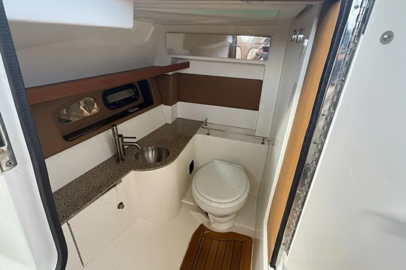  Yacht Photos Pics 2015 Sea Ray SLX 350 boat bathroom with sink, toilet, and wooden flooring.
