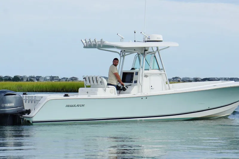  Yacht Photos Pics 2006 Regulator 32 Forward Seating boat on calm water with Yamaha engine.