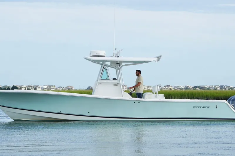  Yacht Photos Pics 2006 Regulator 32 Forward Seating boat on calm water with scenic background.