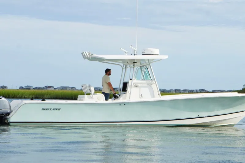  Yacht Photos Pics 2006 Regulator 32 Forward Seating boat on calm water, side view.