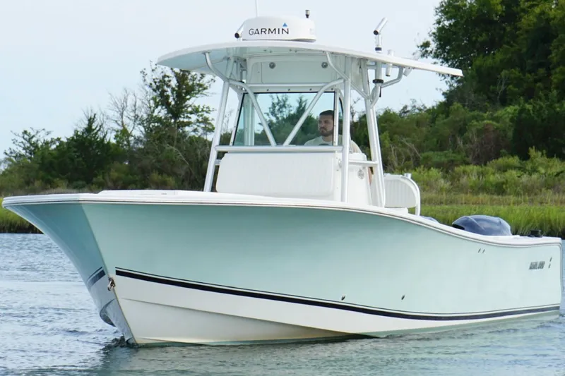  Yacht Photos Pics 2006 Regulator 32 Forward Seating boat cruising on a calm waterway.