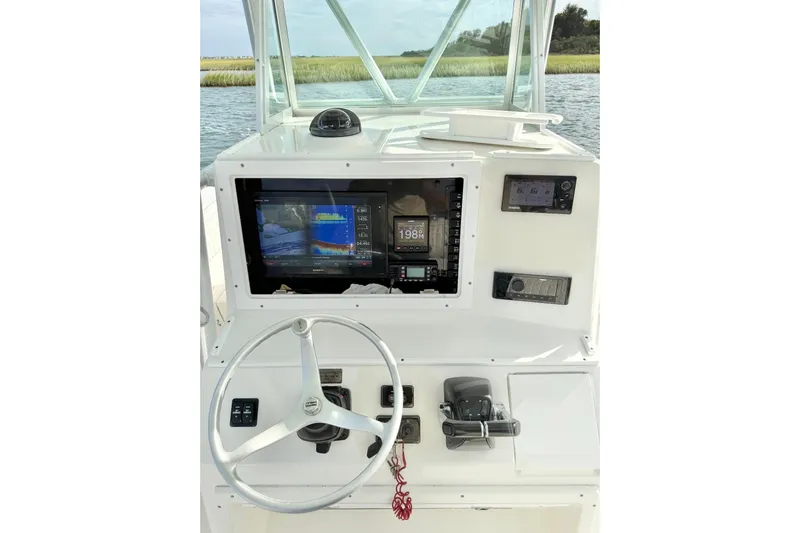  Yacht Photos Pics 2006 Regulator 32 Forward Seating boat dashboard with navigation equipment and steering wheel.