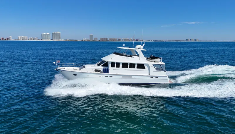  Yacht Photos Pics 2007 Jefferson Marquessa yacht cruising on open water with city skyline in background.