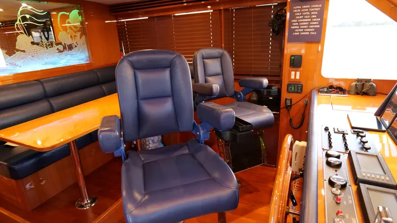  Yacht Photos Pics Interior of 2007 Jefferson Marquessa yacht with blue leather chairs and wooden accents.