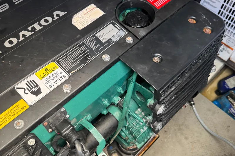  Yacht Photos Pics Engine compartment of a 2015 Prestige 450 with Volvo components and caution labels.