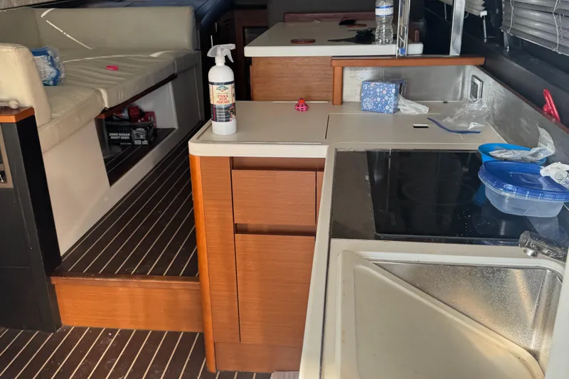  Yacht Photos Pics Interior of a 2015 Prestige 450 yacht kitchen with modern amenities and seating area.