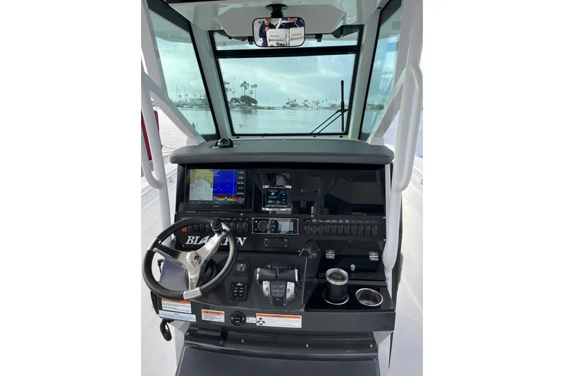  Yacht Photos Pics 2019 Blackfin 272 CC boat dashboard with steering wheel and navigation displays.