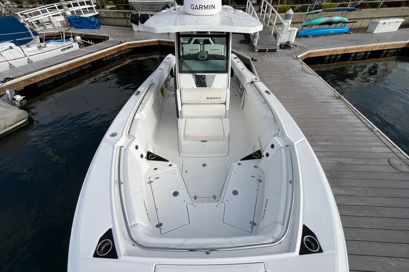  Yacht Photos Pics 2019 Blackfin 272 CC boat docked, featuring spacious deck and Garmin equipment.