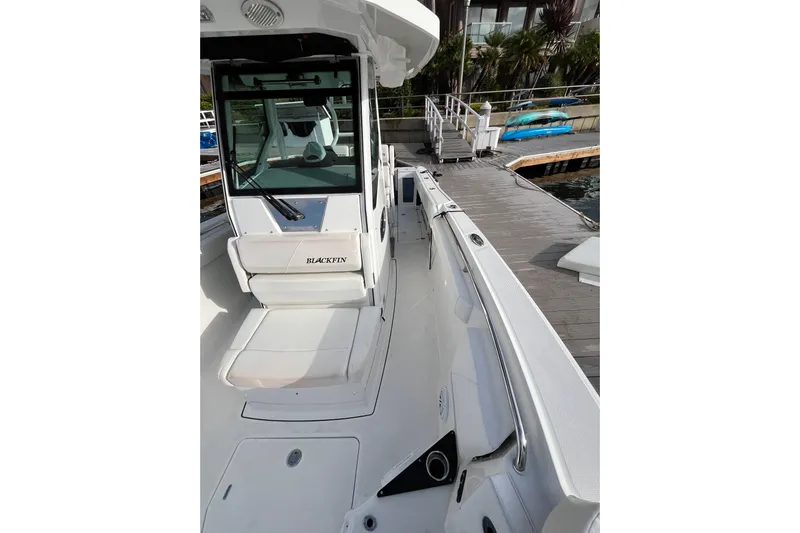  Yacht Photos Pics 2019 Blackfin 272 CC boat docked, showcasing sleek design and spacious deck.