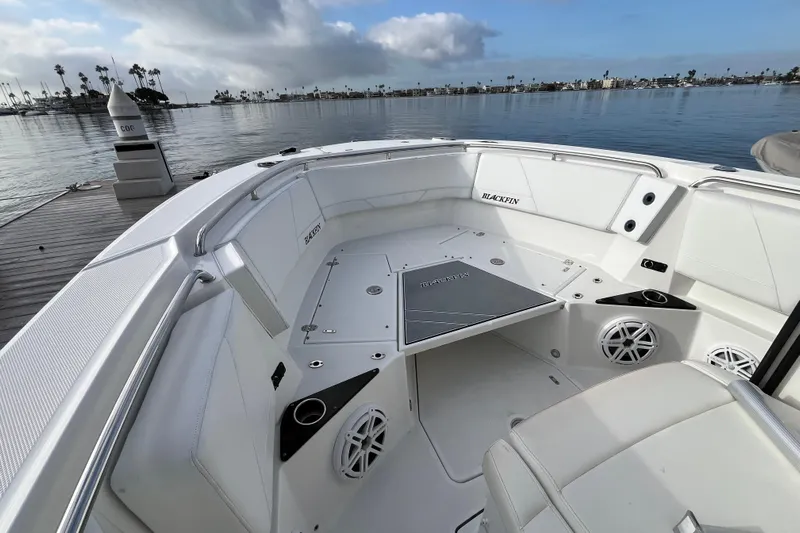  Yacht Photos Pics 2019 Blackfin 272 CC boat interior with white seating, docked by calm waters.