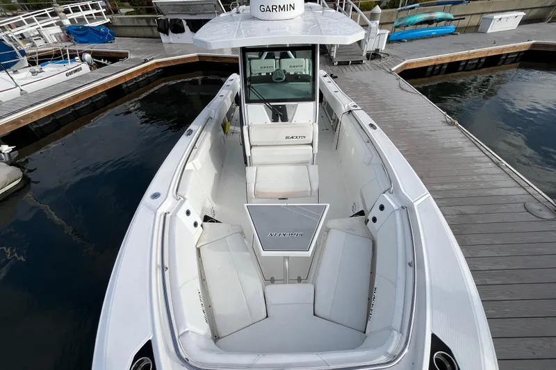  Yacht Photos Pics 2019 Blackfin 272 CC boat docked, featuring spacious seating and Garmin navigation.