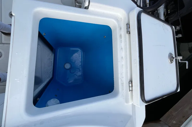  Yacht Photos Pics Livewell compartment on a 2019 Blackfin 272 CC boat, featuring a blue interior.