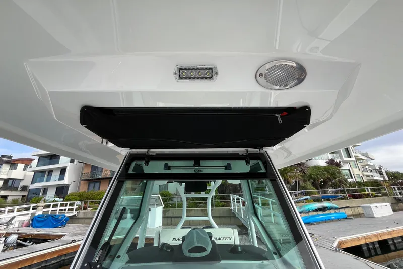  Yacht Photos Pics 2019 Blackfin 272 CC boat interior, featuring helm station and overhead storage.