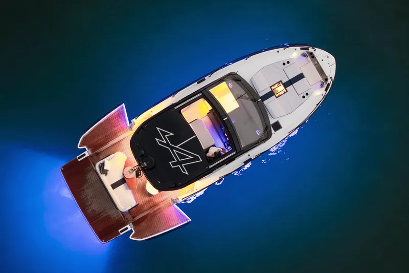  Yacht Photos Pics Aerial view of 2026 Beneteau Gran Turismo 40 yacht with vibrant blue underwater lights.