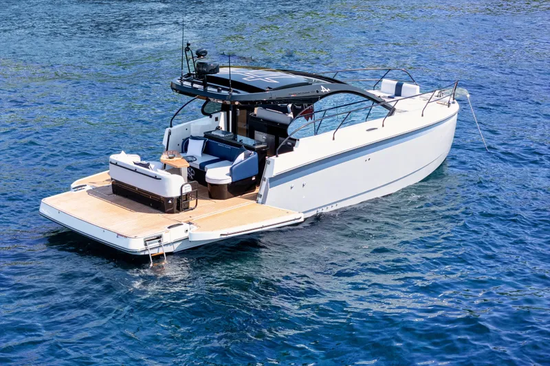  Yacht Photos Pics 2026 Beneteau Gran Turismo 40 yacht on blue water, showcasing sleek design and spacious deck.