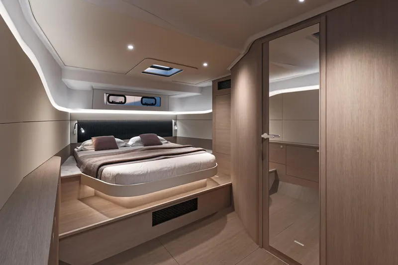  Yacht Photos Pics Luxurious cabin interior of 2026 Beneteau Gran Turismo 40 yacht, featuring modern design and cozy bedding.