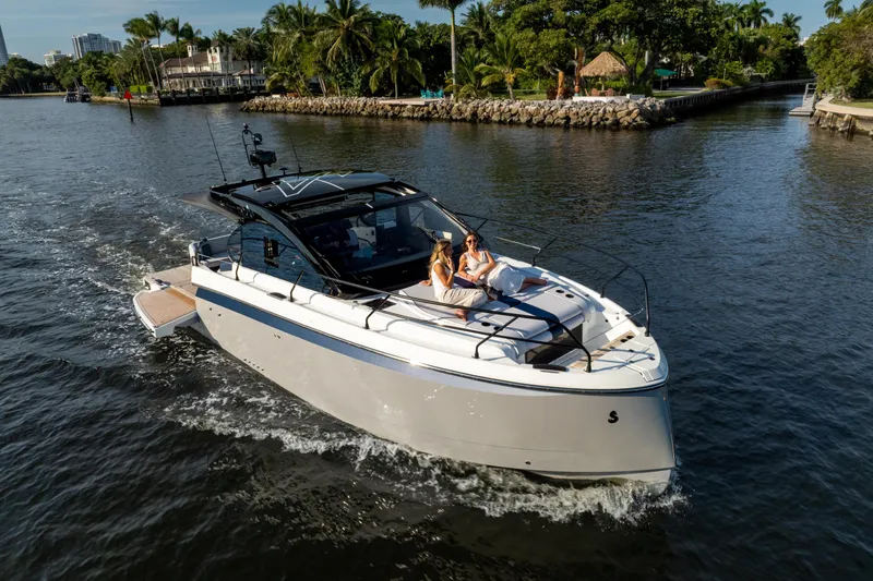  Yacht Photos Pics 2026 Beneteau Gran Turismo 40 cruising on a scenic waterway with passengers relaxing onboard.